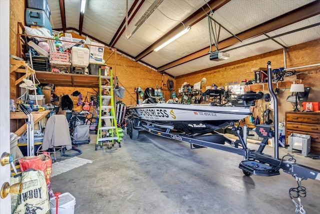 garage featuring a garage door opener and a workshop area