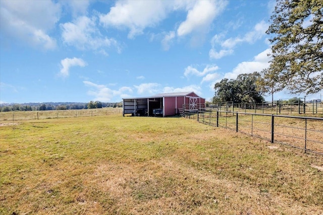 view of yard with an outbuilding and a rural view