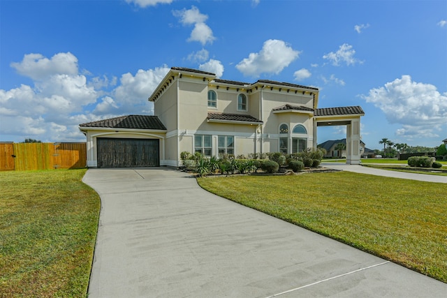 mediterranean / spanish home with a front lawn and a garage