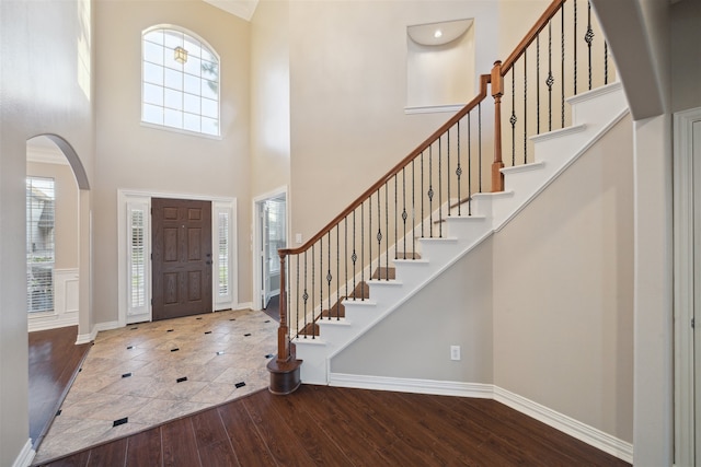 entryway featuring hardwood / wood-style floors and a high ceiling