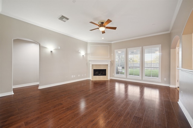 unfurnished living room with crown molding, dark hardwood / wood-style floors, and ceiling fan