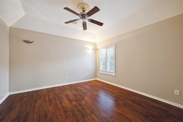 unfurnished room with dark wood-type flooring, a textured ceiling, and ceiling fan