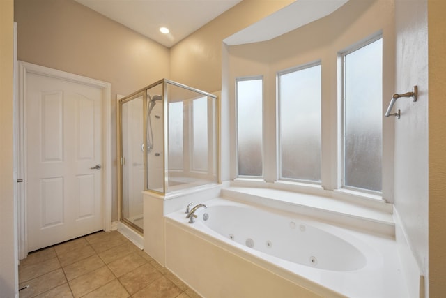 bathroom with independent shower and bath and tile patterned flooring