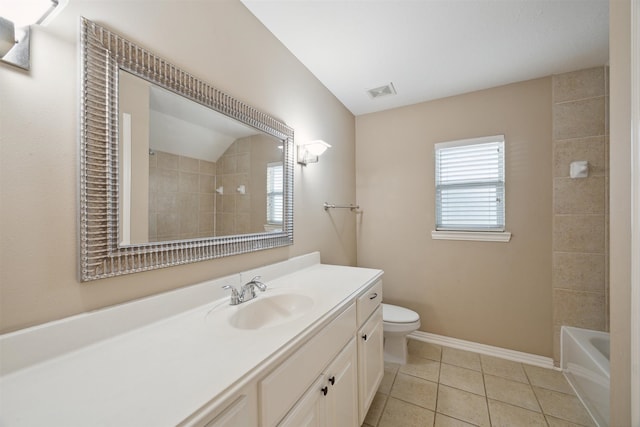 full bathroom featuring lofted ceiling, toilet, vanity, tiled shower / bath combo, and tile patterned flooring