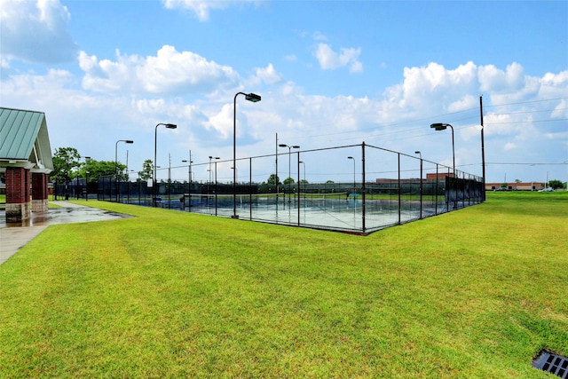 view of sport court featuring a lawn