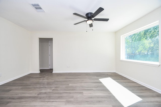 spare room featuring dark hardwood / wood-style flooring and ceiling fan