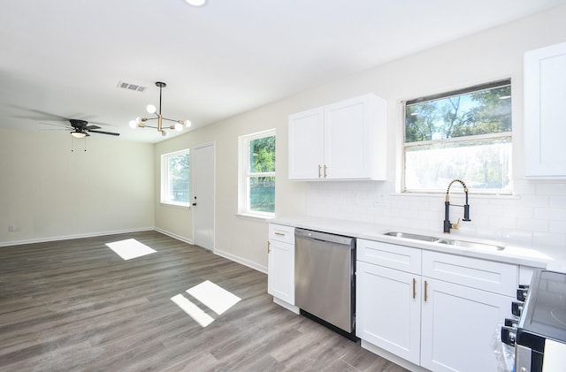 kitchen with sink, dishwasher, range, tasteful backsplash, and white cabinets