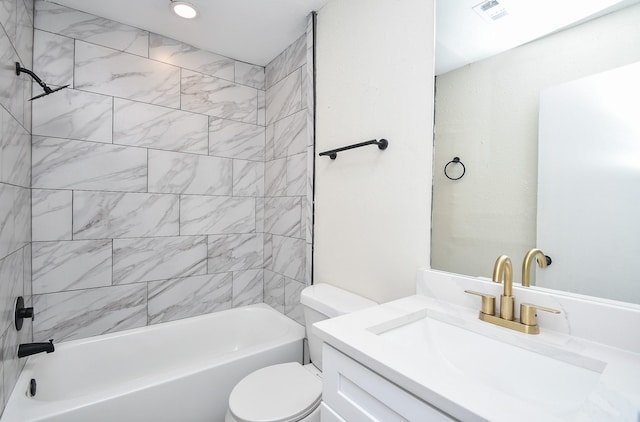 full bathroom featuring vanity, tiled shower / bath combo, and toilet