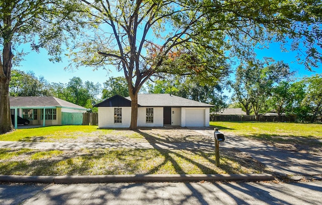 single story home featuring a front yard and a garage