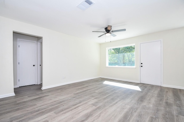 empty room featuring hardwood / wood-style floors and ceiling fan