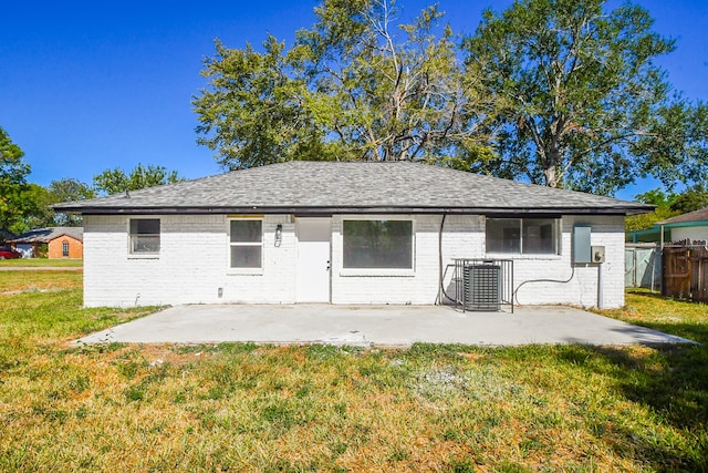 back of property featuring a patio, central air condition unit, and a lawn