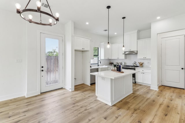 kitchen featuring a center island, white cabinetry, appliances with stainless steel finishes, and light hardwood / wood-style flooring