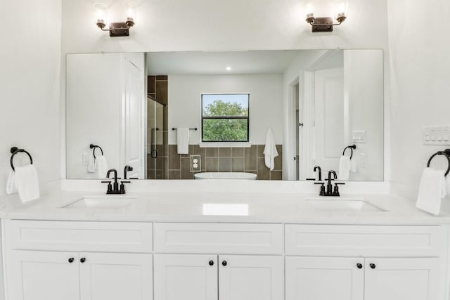 bathroom featuring vanity, an enclosed shower, and decorative backsplash