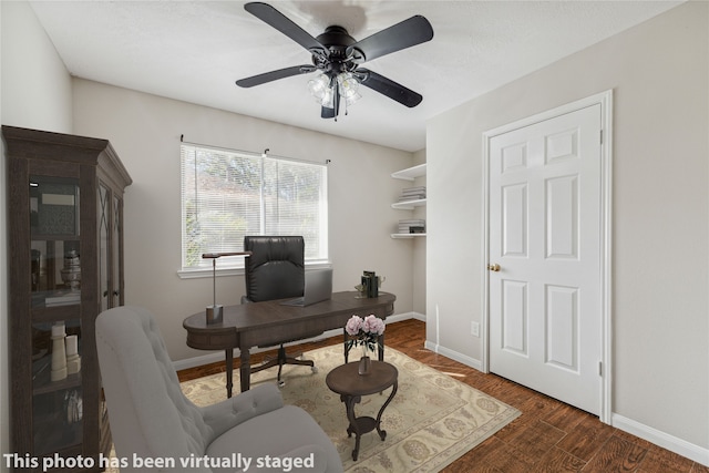 office area with dark wood-type flooring and ceiling fan