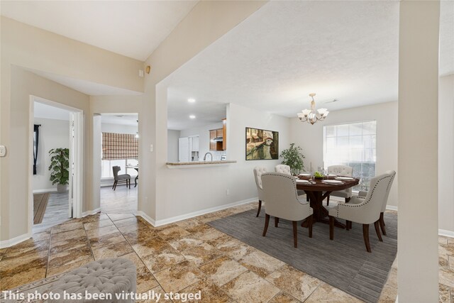 dining space with a notable chandelier and sink