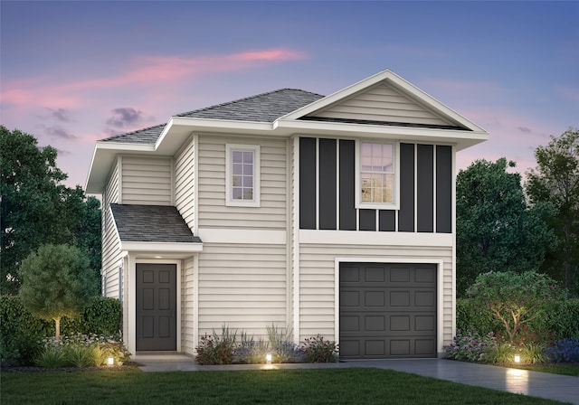 view of front of home with a lawn and a garage