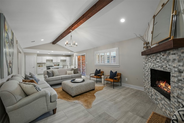 living room with a tiled fireplace, lofted ceiling with beams, and a chandelier