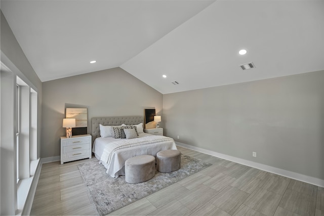 bedroom featuring light hardwood / wood-style floors and vaulted ceiling