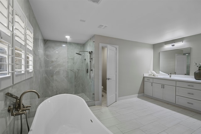 bathroom featuring vanity, shower with separate bathtub, and tile patterned floors