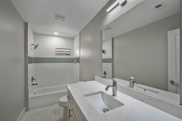 full bathroom featuring vanity, tiled shower / bath combo, toilet, and tile patterned flooring