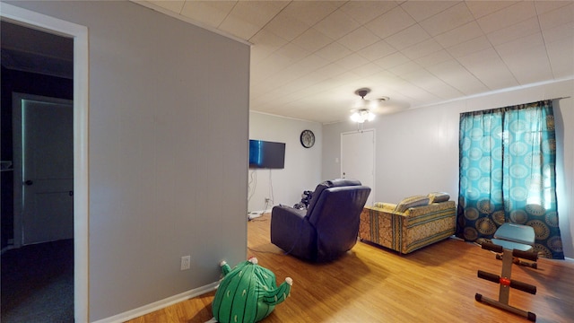 interior space featuring ornamental molding, hardwood / wood-style floors, and ceiling fan