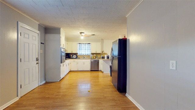 kitchen with sink, white cabinetry, stainless steel appliances, ornamental molding, and light hardwood / wood-style flooring