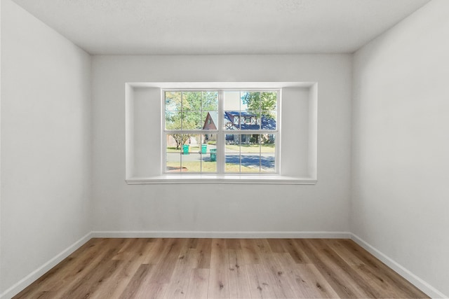 unfurnished room with light hardwood / wood-style floors