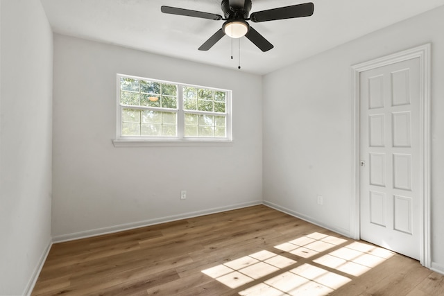 empty room with ceiling fan and light hardwood / wood-style flooring