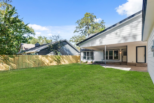 back of house featuring a yard and a patio