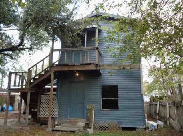 rear view of property featuring a wooden deck