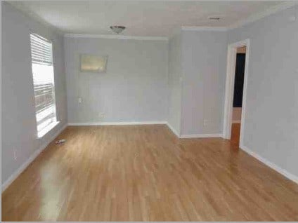 4716 Mierianne St, Houston, TX 77093 - spare room featuring crown molding, baseboards, and wood finished floors