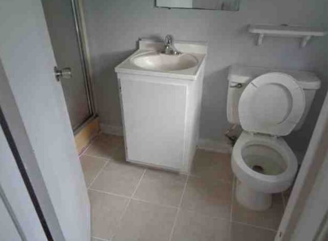 4716 Mierianne St, Houston, TX 77093 - bathroom featuring vanity, tile patterned floors, a stall shower, and toilet