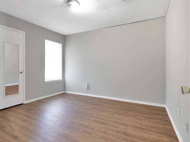 spare room with hardwood / wood-style floors