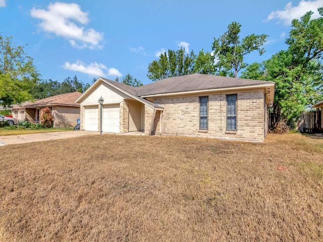 ranch-style home featuring a front yard and a garage