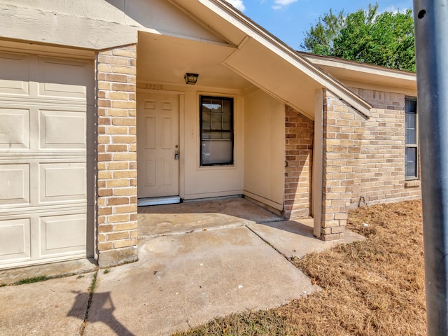 doorway to property with a garage