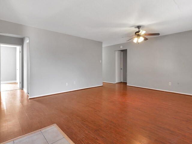 spare room featuring light hardwood / wood-style flooring and ceiling fan