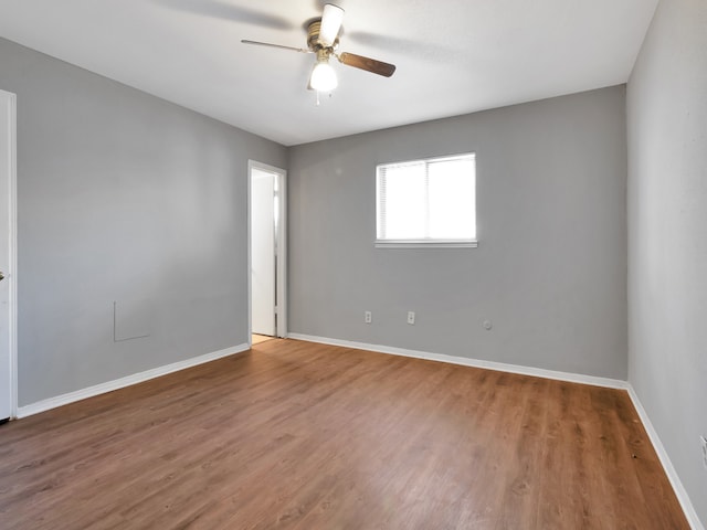 unfurnished room with ceiling fan and hardwood / wood-style floors