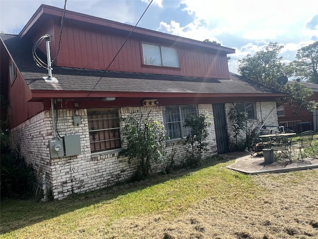 rear view of property with a patio area and a lawn