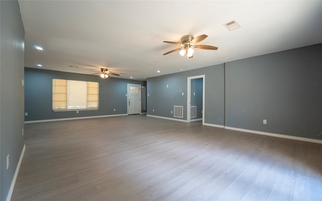 empty room with ceiling fan and wood-type flooring