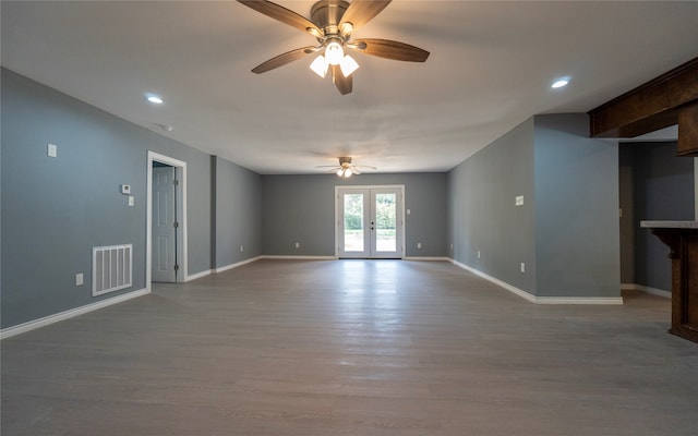 spare room featuring french doors, ceiling fan, and wood-type flooring