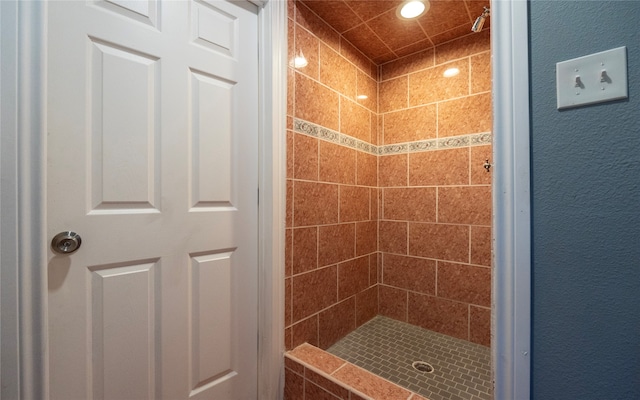 bathroom with tiled shower