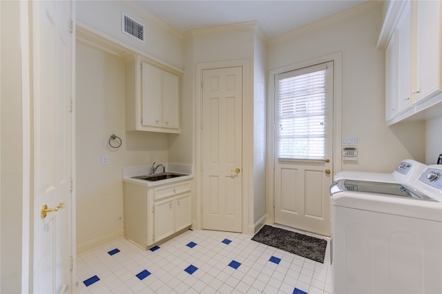 laundry area featuring ornamental molding, light tile patterned floors, cabinets, sink, and washing machine and dryer