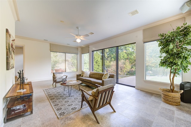 living room featuring ornamental molding, a wealth of natural light, and ceiling fan