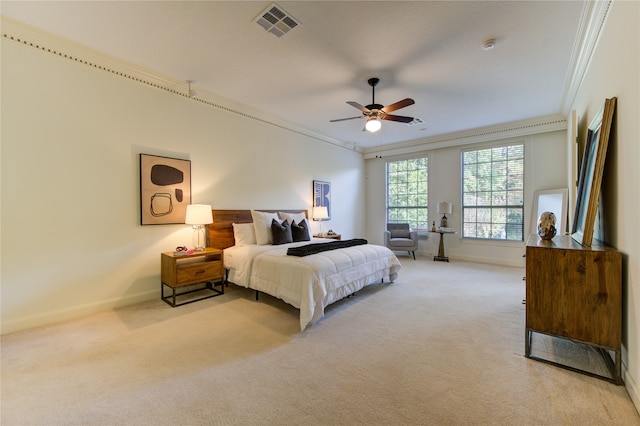 carpeted bedroom featuring ceiling fan and crown molding