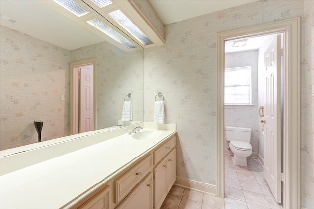 bathroom with vanity, tile patterned flooring, and toilet