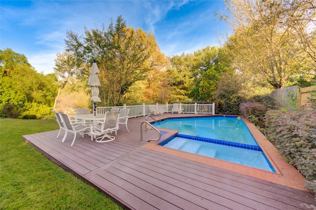 view of swimming pool with a wooden deck and a yard