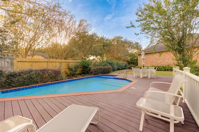 view of swimming pool with a deck