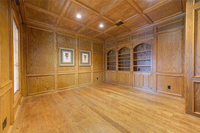 unfurnished room featuring built in shelves, light wood-type flooring, wood walls, coffered ceiling, and wooden ceiling