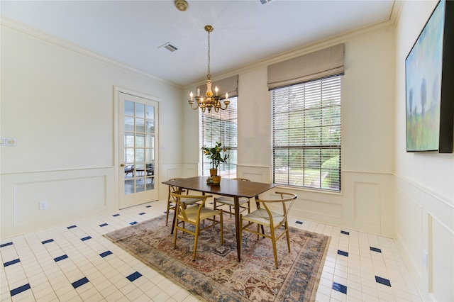 tiled dining space featuring a chandelier and ornamental molding