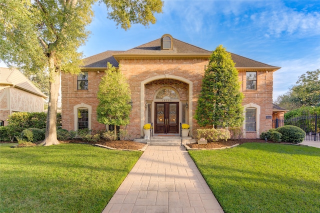 view of front of house featuring a front lawn and french doors